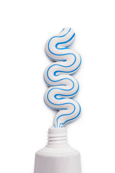 Blue and white stripy toothpaste squiggling out of tube